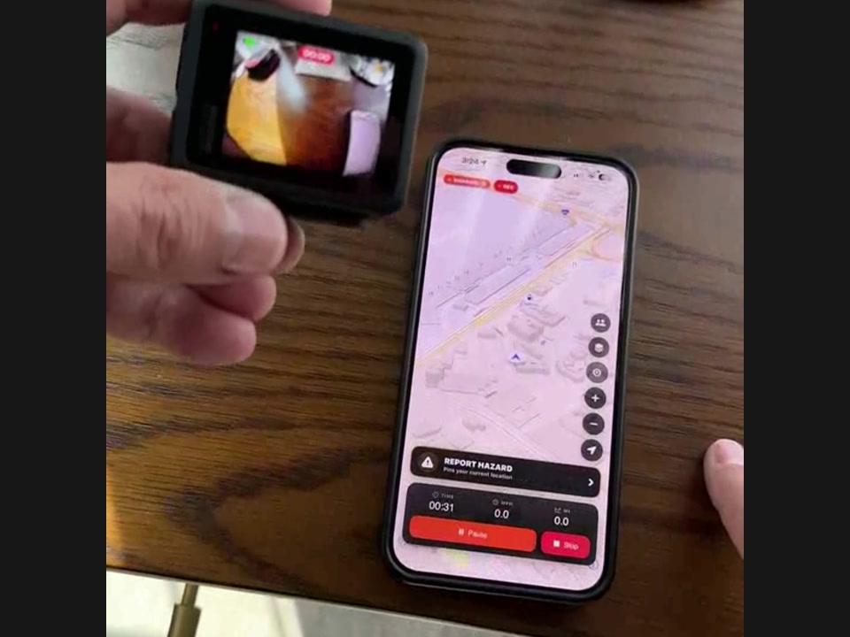 A GoPro recording beside a phone showing the RiderShield active-ride screen.